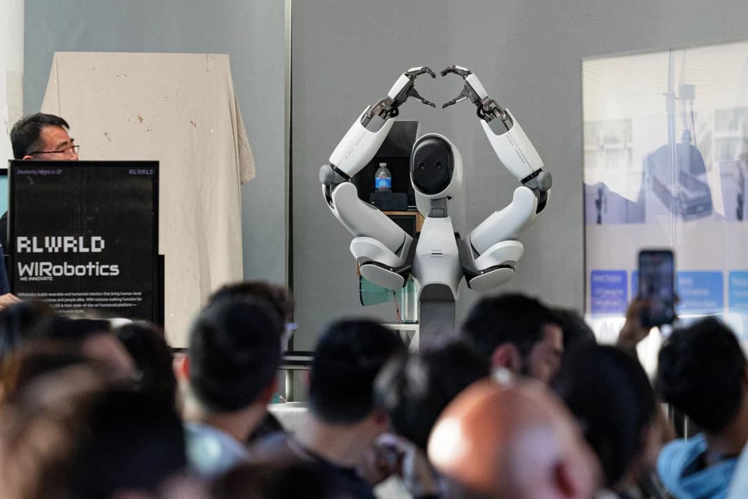 A robot making a heart shape with its hands during Dexterity Night.